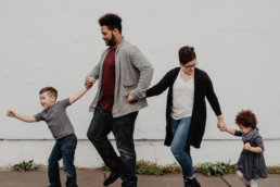 Young parents walking with their 2 children